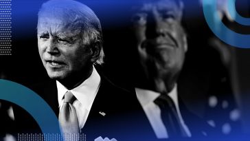 A photo of President Joe Biden with former President Donald Trump on a screen behind him.